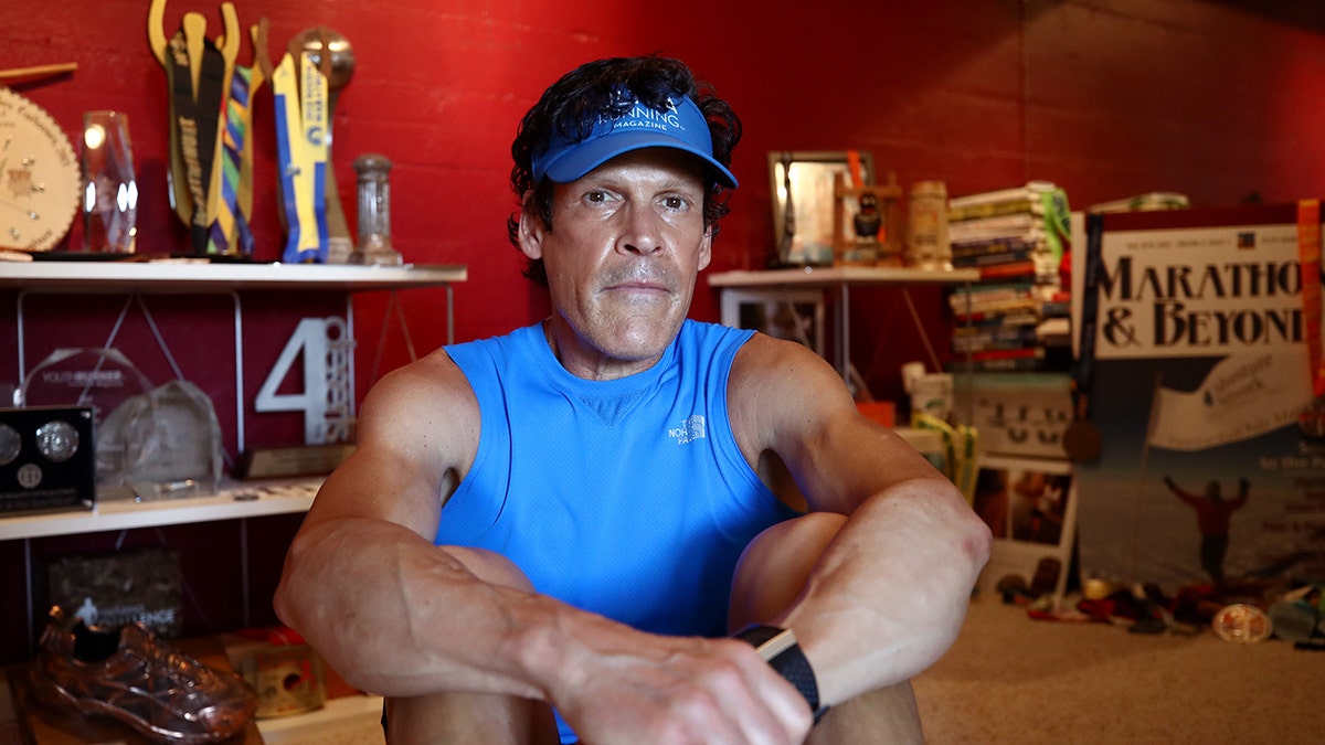 Dean Karnazes poses with his medals