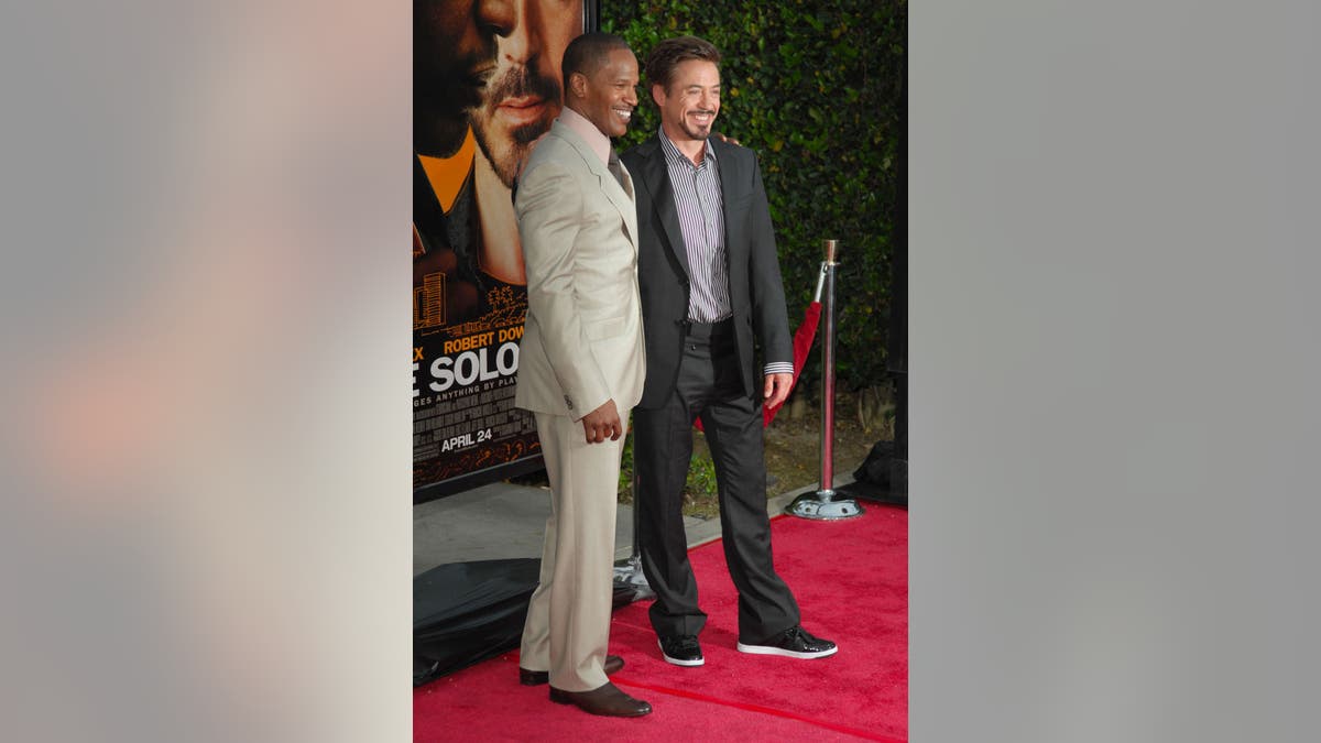 Robert Downey Jr. and Jamie Foxx attend a premiere