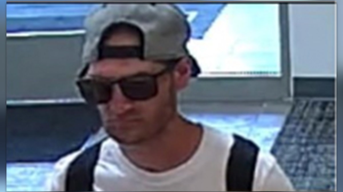 Empty Promise Bandit wearing sunglasses and a backward hat, with stubble