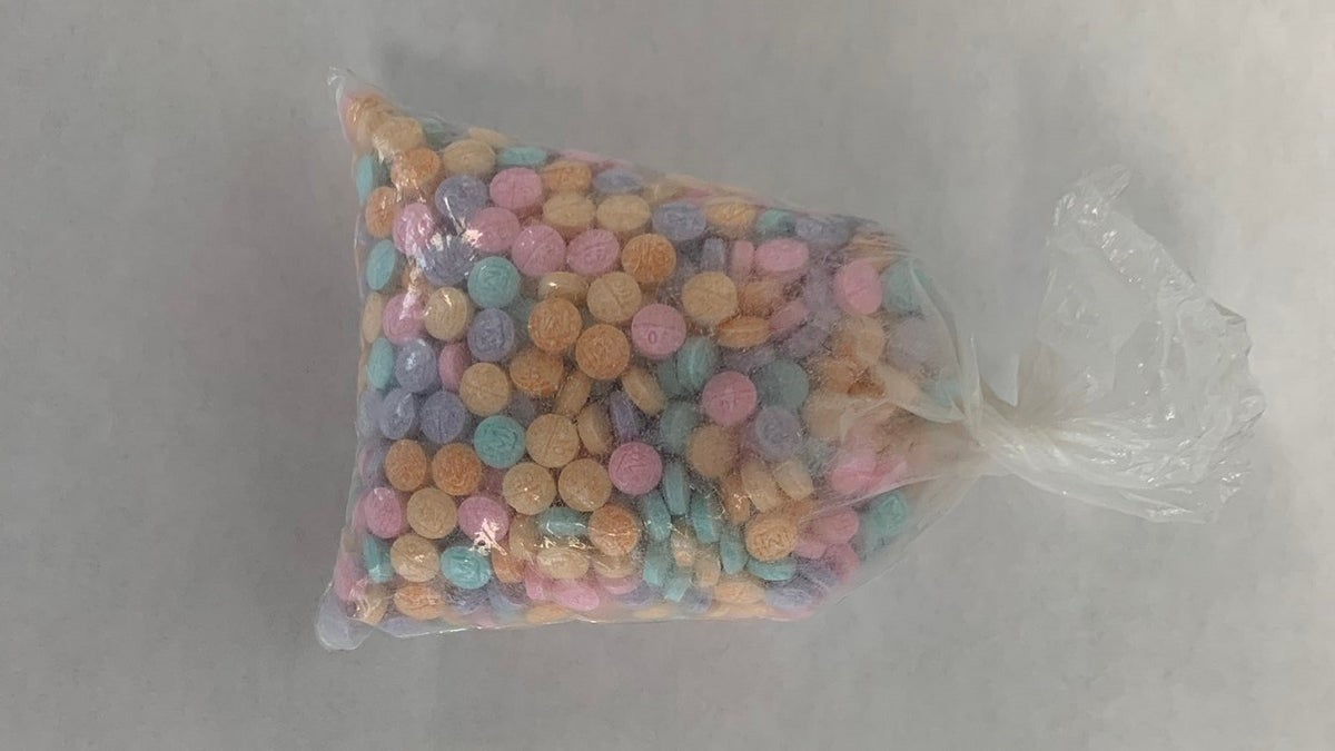 multi-colored pills of the deadly fentanyl drug in a plastic bag