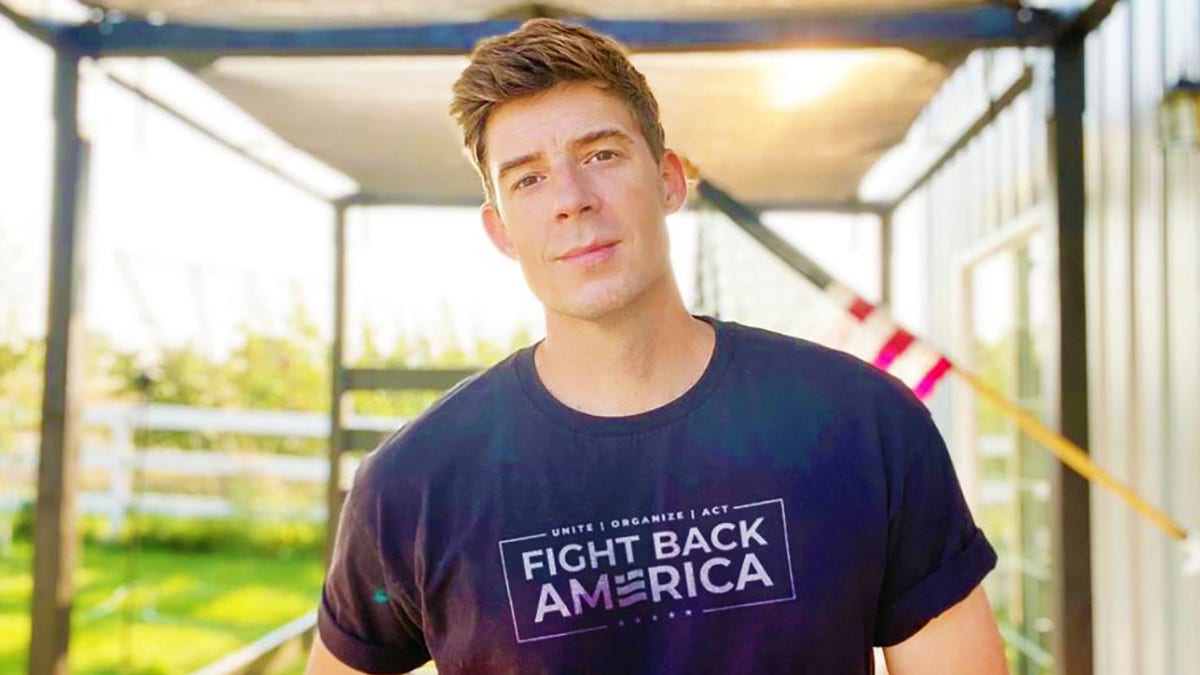Corey Gibson pictured with a shirt that reads "Fight Back America"
