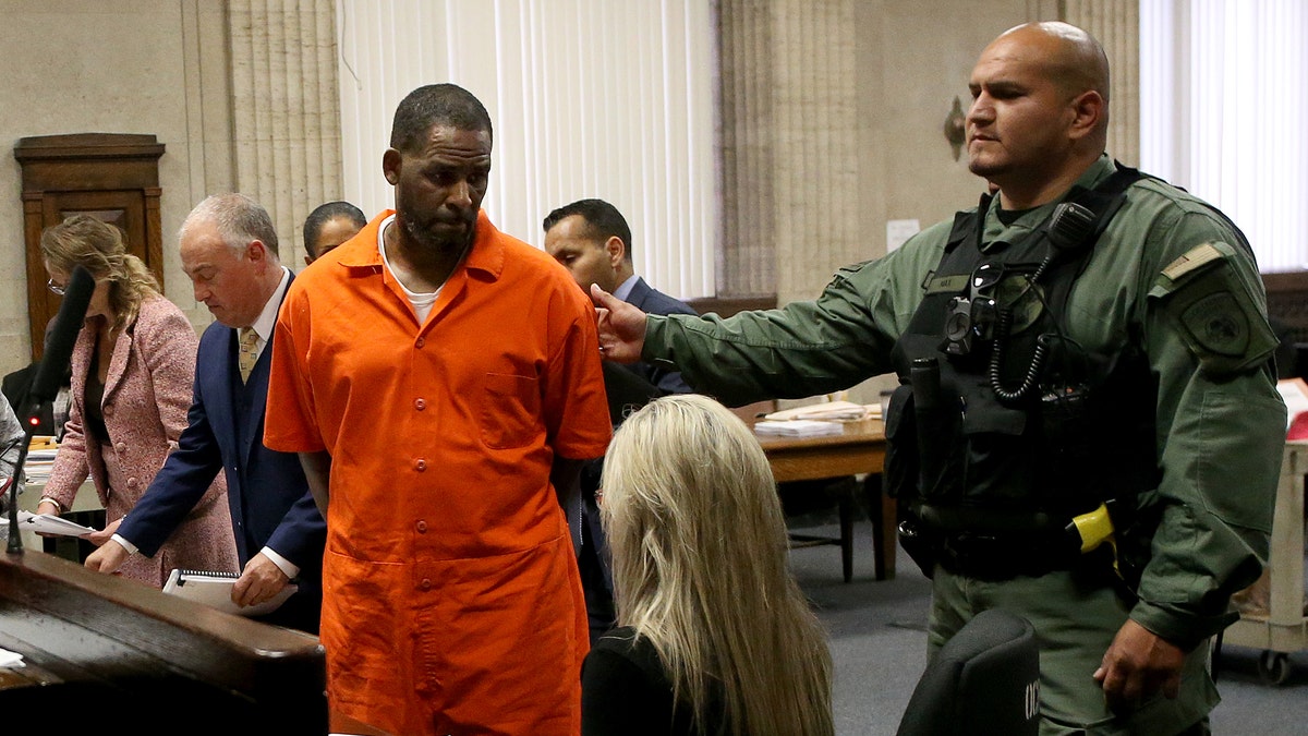 R. Kelly wearing an orange jumpsuit in court