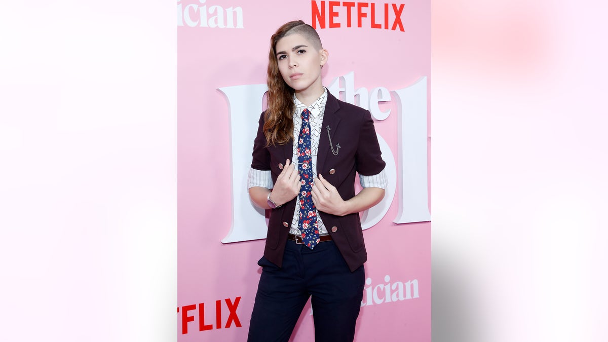 Transgender activist Eli Erlick in a suit at a Netflix premiere in 2019