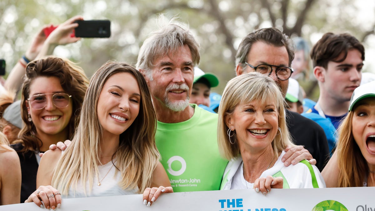 Olivia Newton-John with her husband and daughter