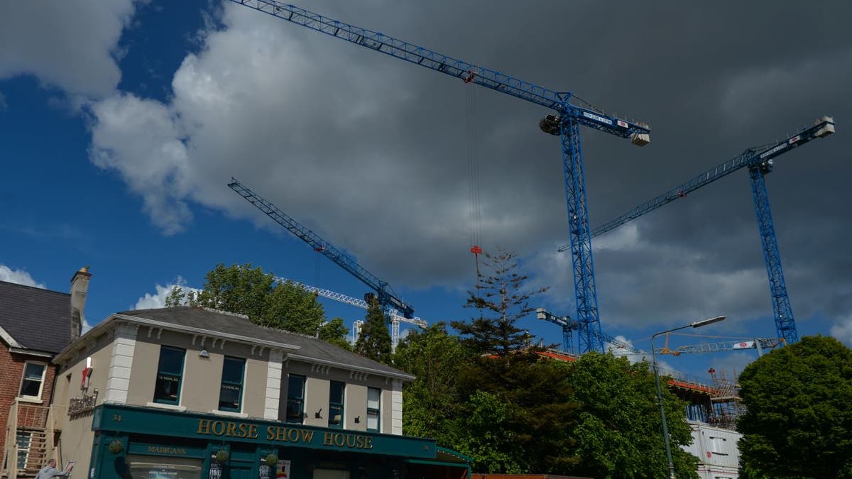 Cranes high above a construction site in Dublin, Ireland