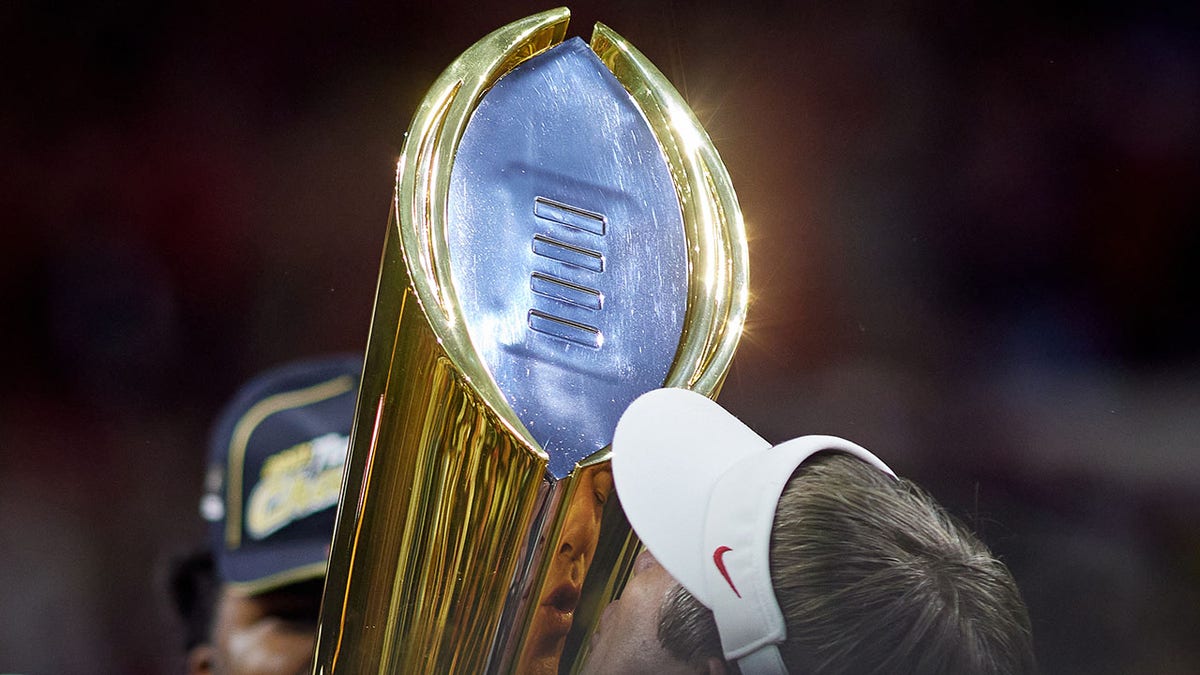 Kirby Smart holds the national championship trophy