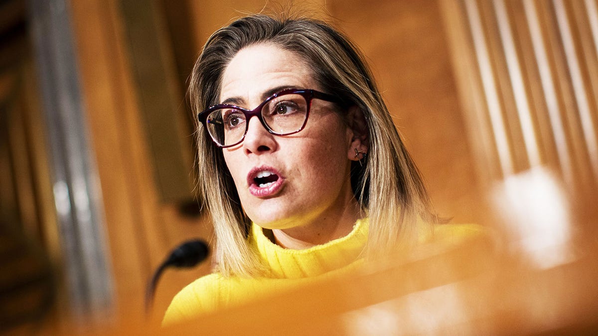 Progressive groups take aim at Sinema over decision to remove carried interest tax loophole from Manchin bill