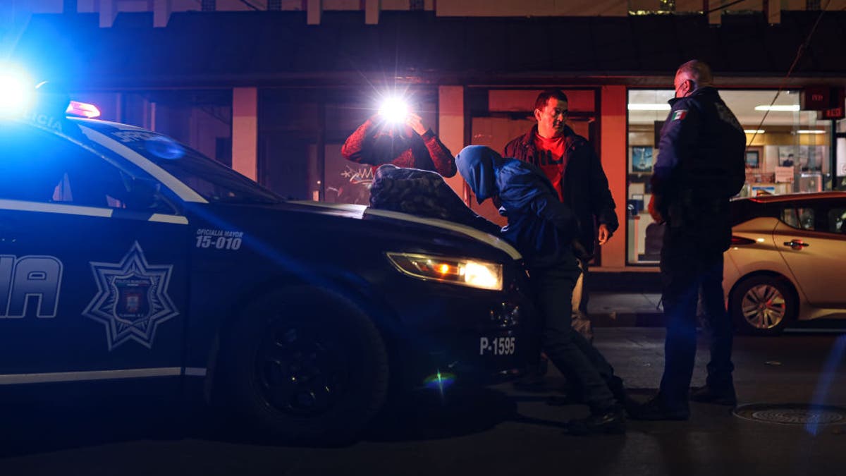 Police officers arrest a resident