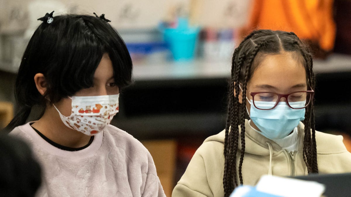 School children wearing masks in classroom