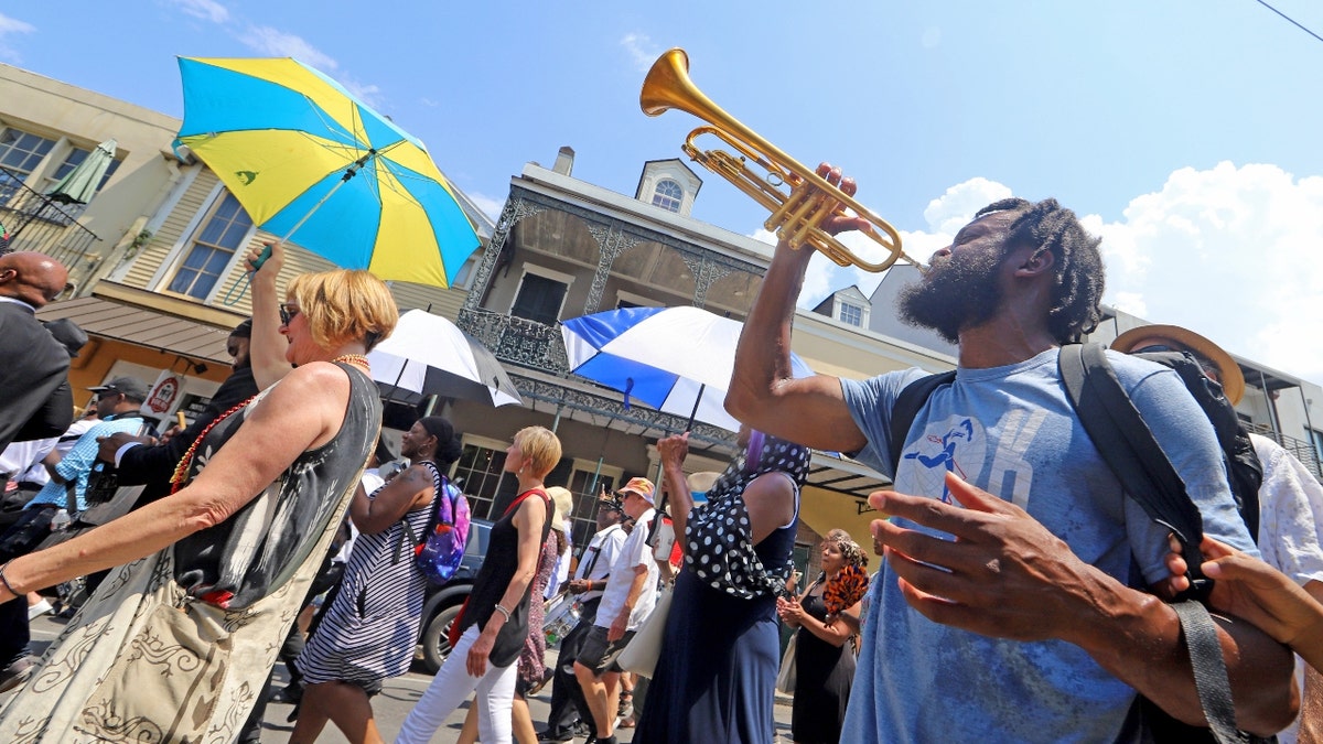 A second line honoring legendary jazz pianist and educator Ellis Marsalis Jr. makes its way through downtown on May 15, 2022 in New Orleans, Louisiana.