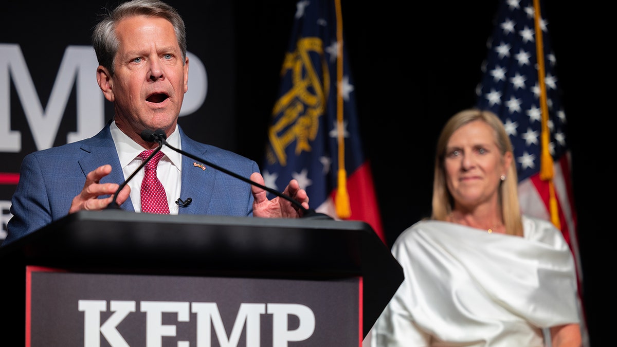 Gov. Brian Kemp speaks to a crowd in Atlanta