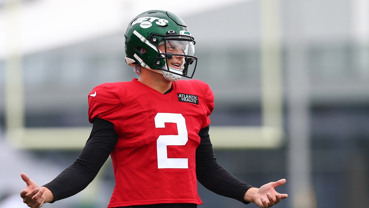 Zach Wilson gestures during training camp