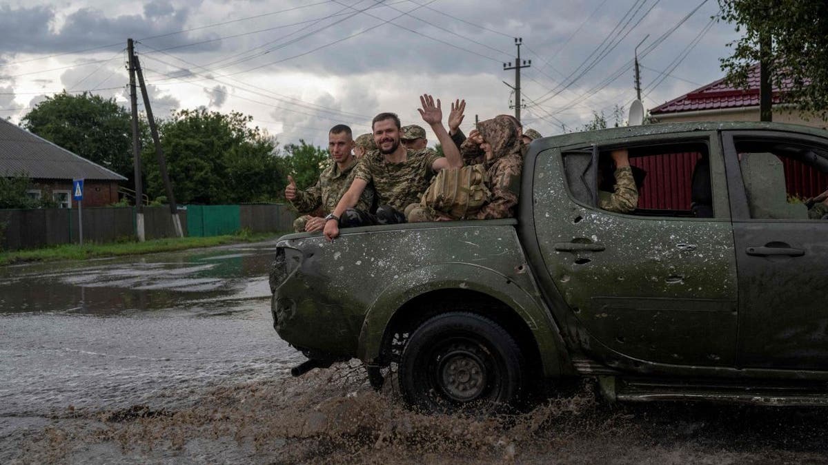 Ukrainian soldiers wave
