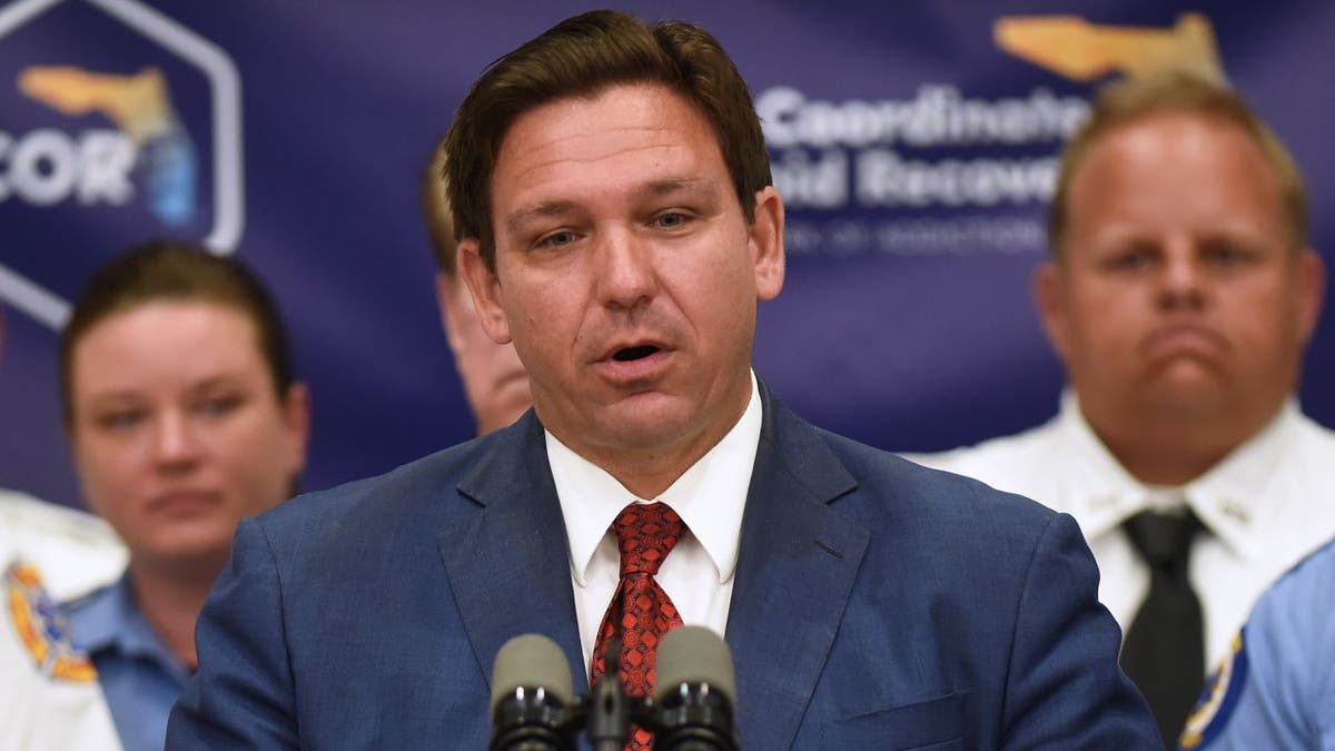 Florida Gov. Ron DeSantis at substance abuse press conference wearing blue suit and red tie