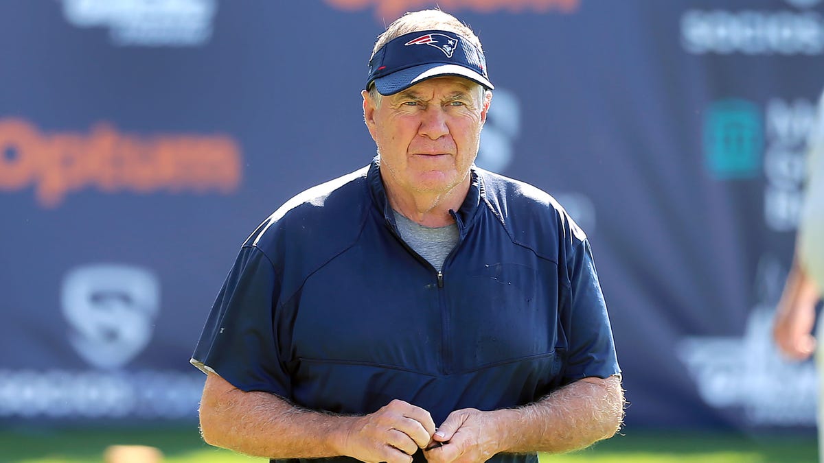 Bill Belichick walks at Patriots training camp