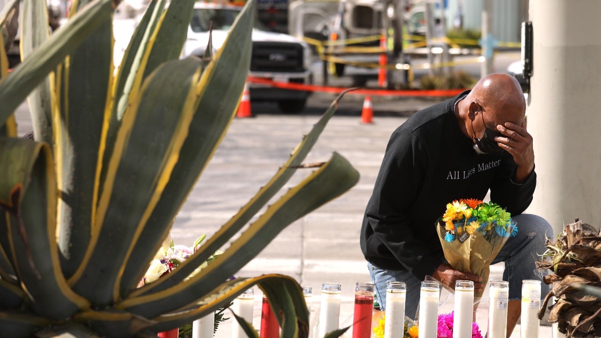 Man weeps beside memorial site for Los Angeles car crash victims