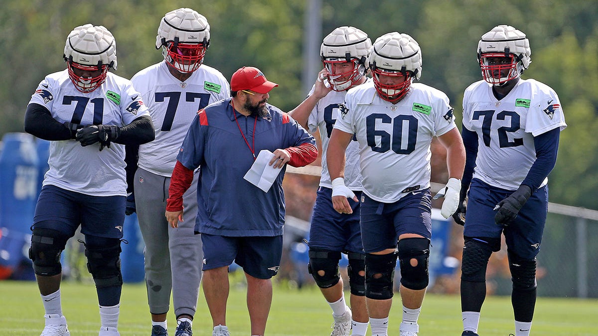 New England Patriots offensive line coach Matt Patricia and, from left, Mike Onwenu, Trent Brown, Cole Strange, David Andrews  and Yodny Cajuste during training camp at Gillette Stadium on Aug. 15, 2022, in Foxboro.
