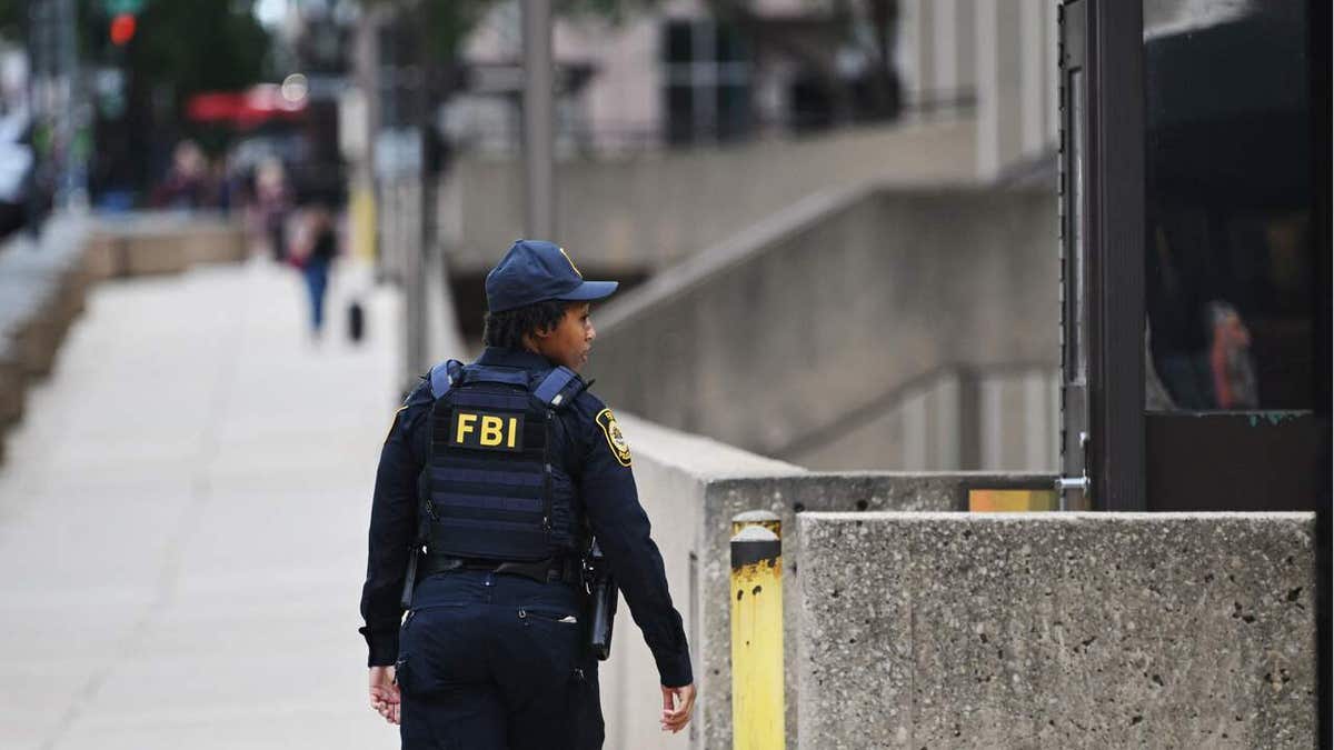 Security personnel patrol around the headquarters of the Federal Bureau of Investigation