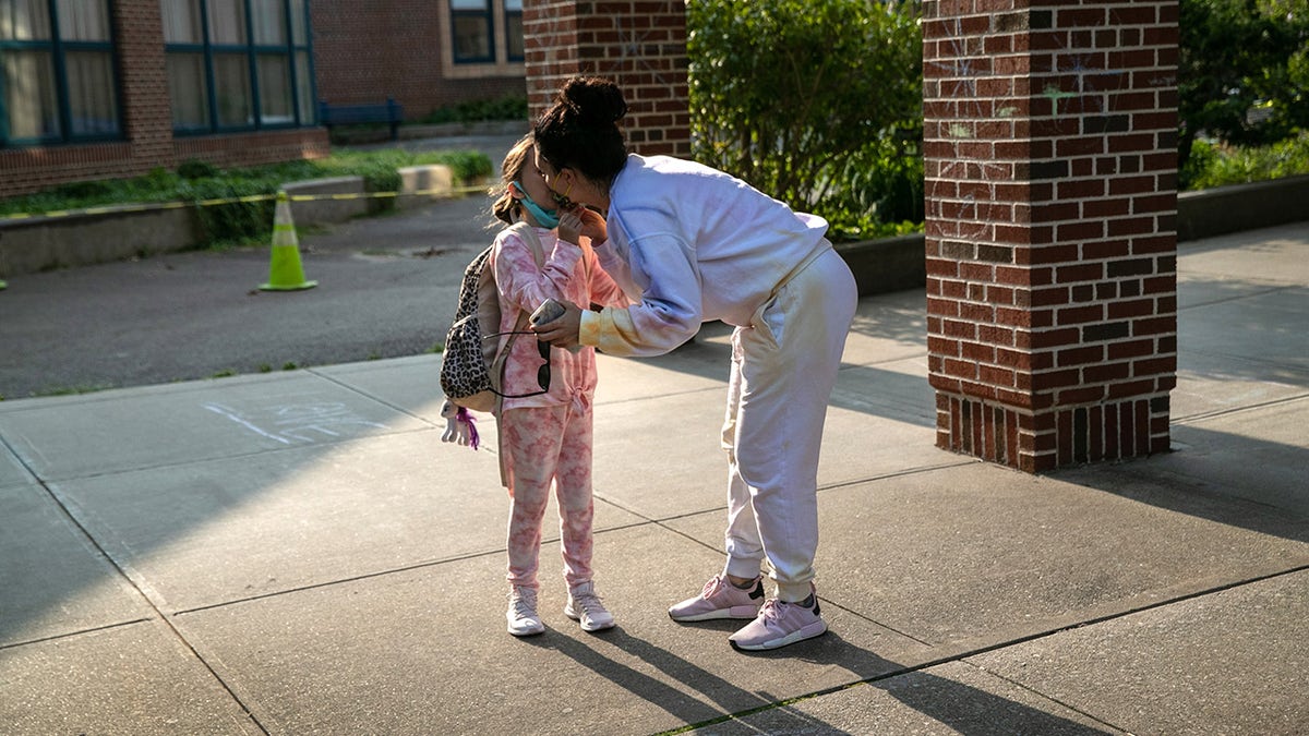 mother drops off daughter at school