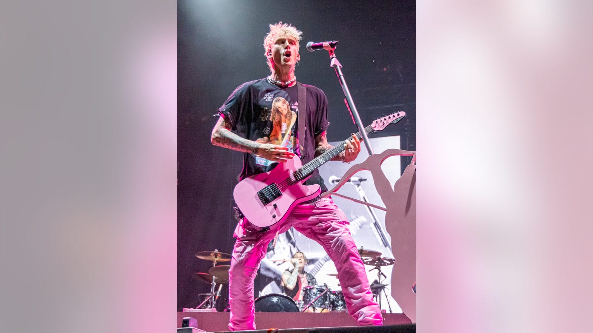 Machine Gun Kelly sings on stage