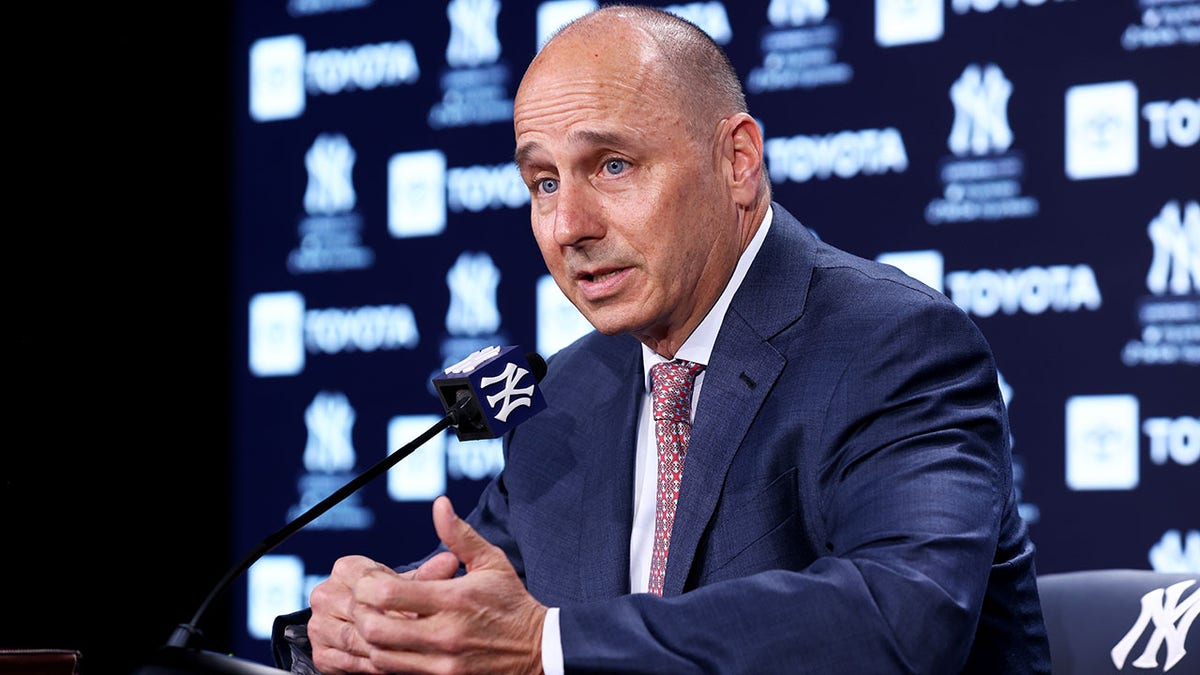 Yankees general manager Brian Cashman speaks with reporters in April