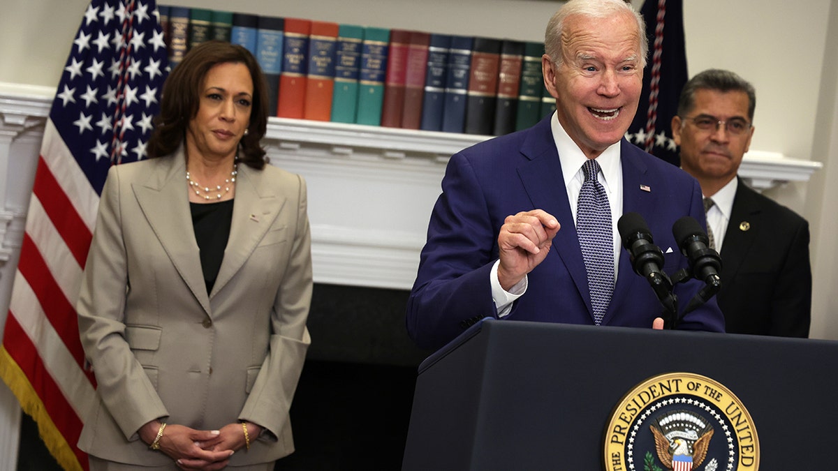 Joe Biden speaking at a podium with Kamala Harris