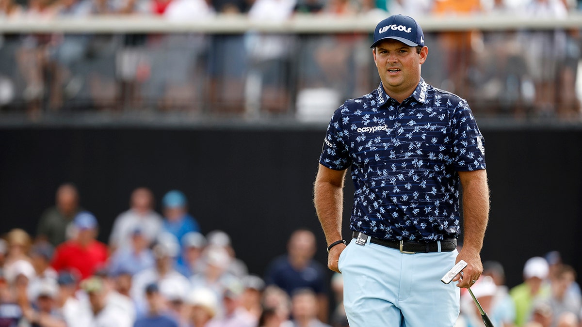 Patrick Reed walks across the green