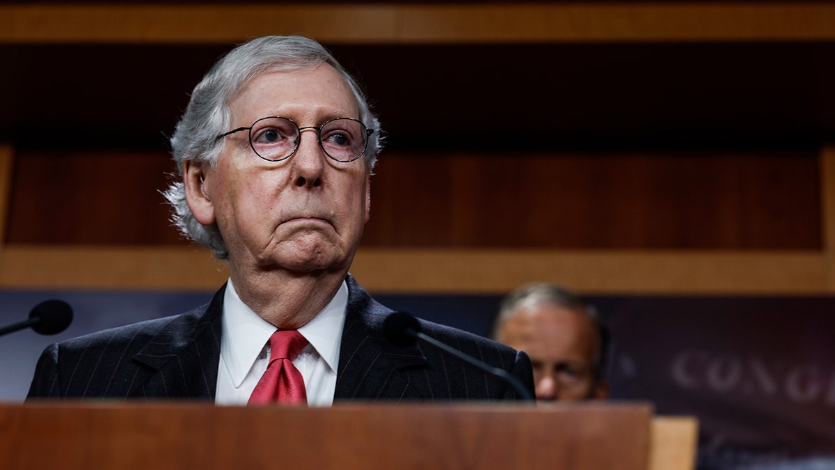 Mitch McConnell behind a podium