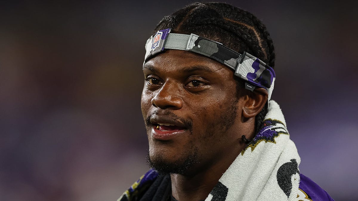 Lamar Jackson looks on during the Ravens first preseason game