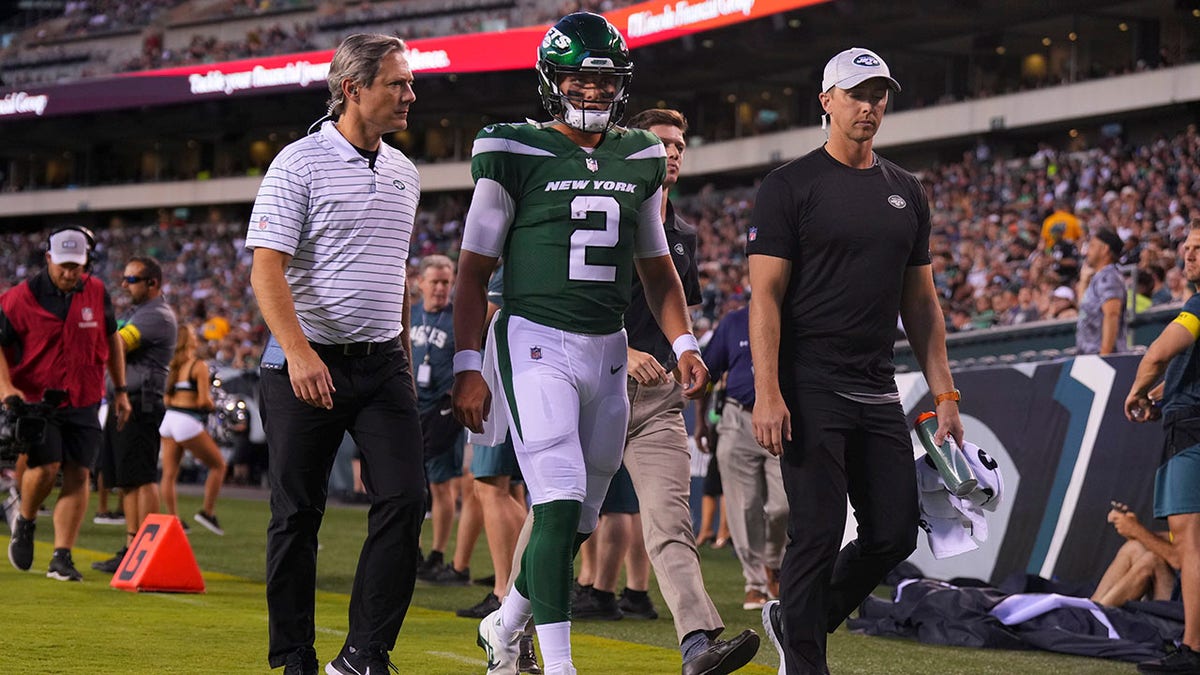 Jets quarterback Zach Wilson exits the field after injuring his knee