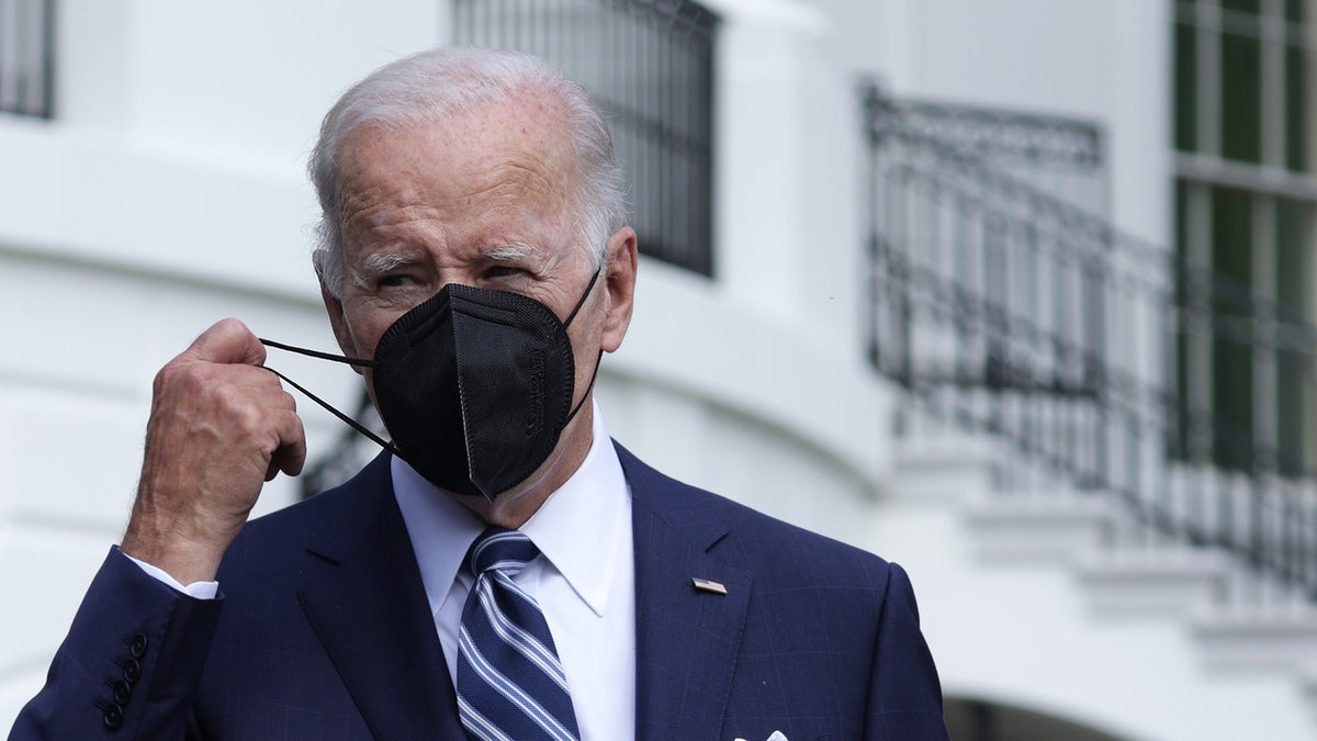 President Joe Biden takes off his mask