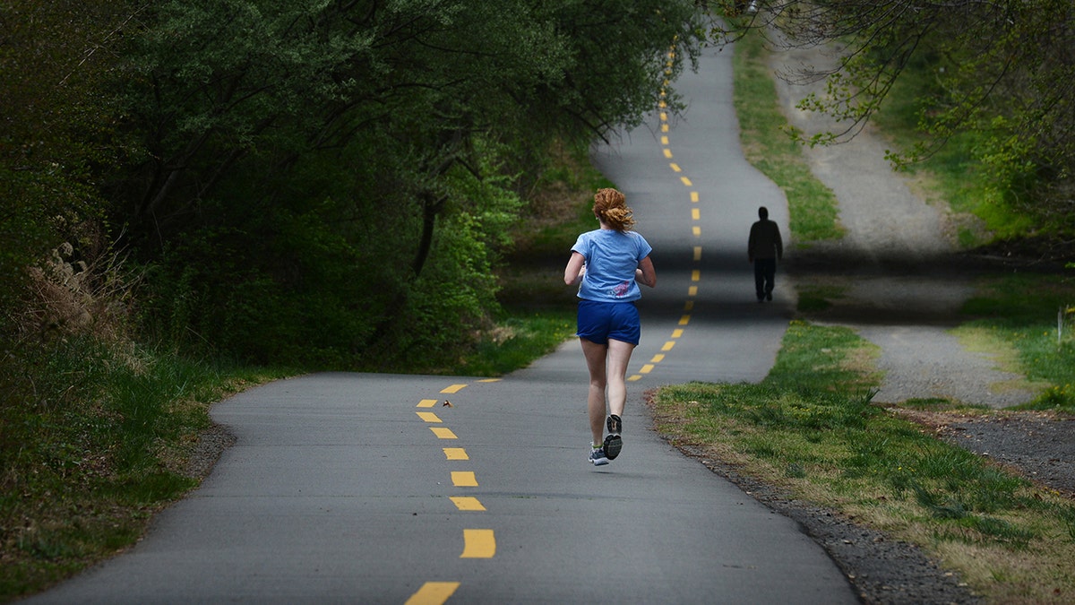 woman runs on W&OD trail