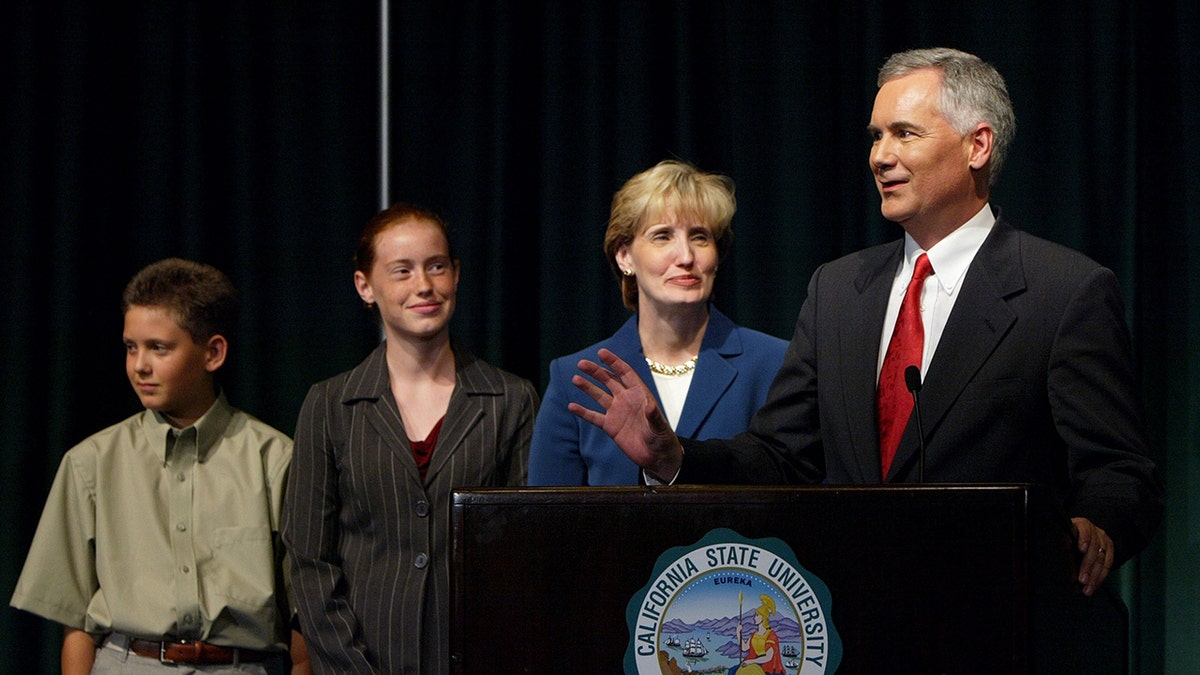 Tom McClintock speaks to reporters with wife