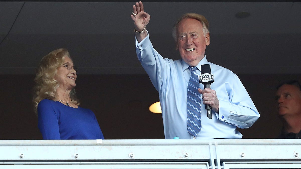 Vin Scully waves to the crowd at Dodger Stadium