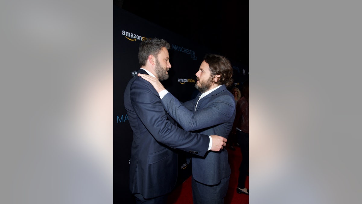 Ben and Casey Affleck hold each other