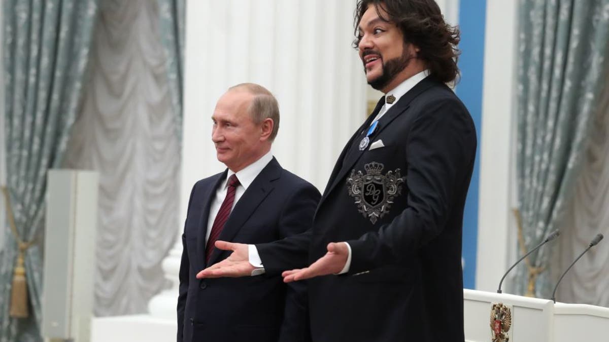 Pop singer Philip Kirkorov with friend Russian President Vladimir Putin, both in suits