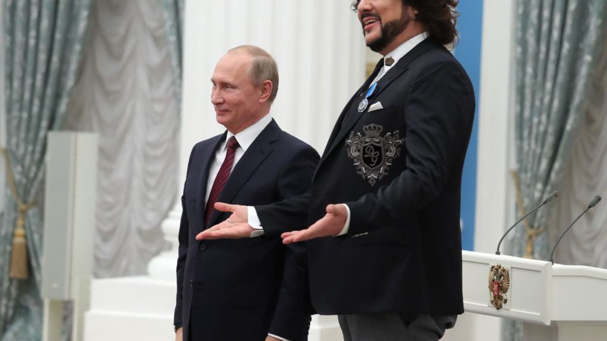 Pop singer Philip Kirkorov with friend Russian President Vladimir Putin, both in suits
