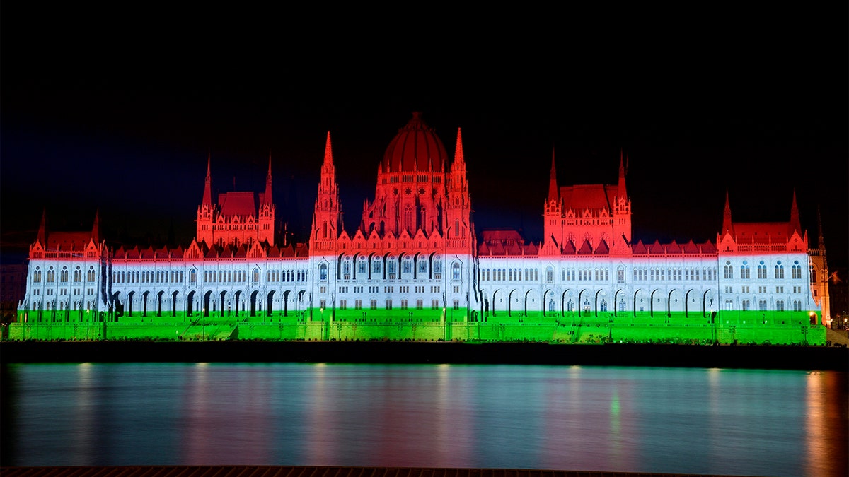 Hungarian Parliament building is lit up in national colors on day celebrating statehood
