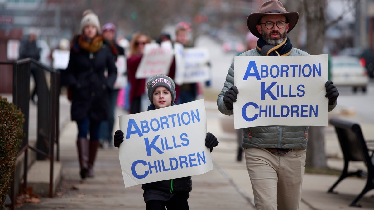 Anti-abortion protesters march from the Monroe County Courthouse around Planned Parenthood and back to the courthouse during the Rally for Life in Bloomington, Indiana.
