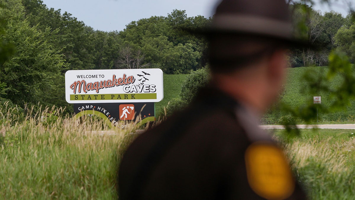 Police officer walking in front of Iowa state park