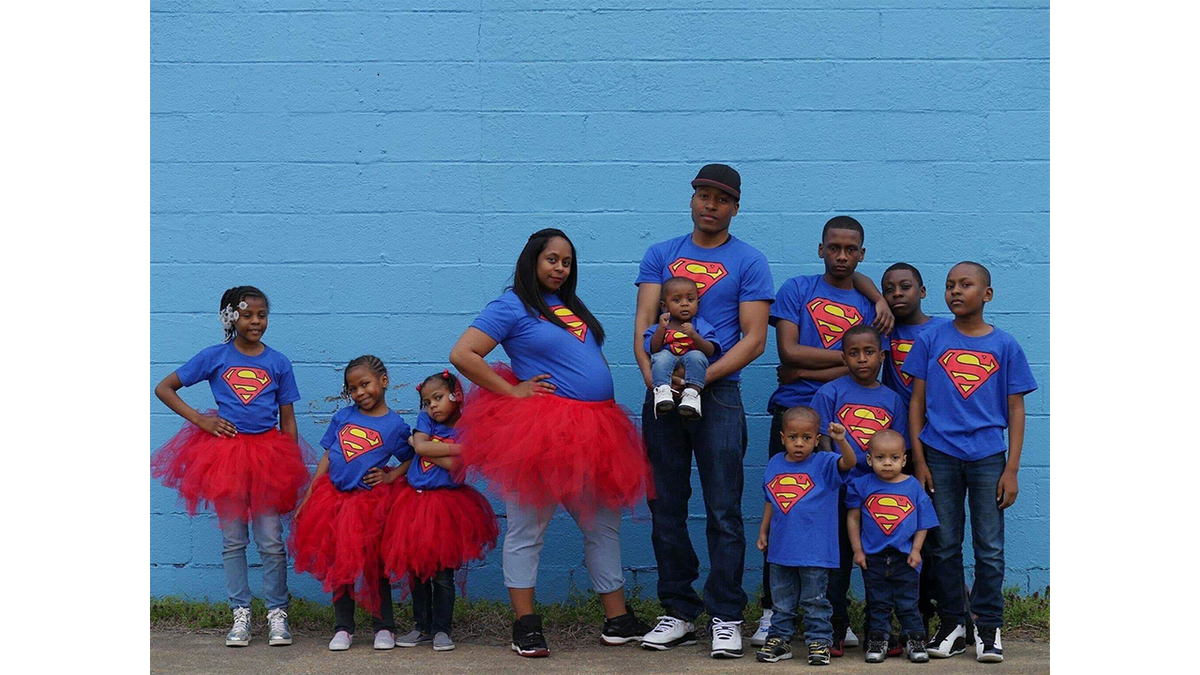 Pictured here in 2017 are Iris and Cordell Purnell, center, with 10 of their children. At the time, Iris was pregnant with the couple's 11th child.