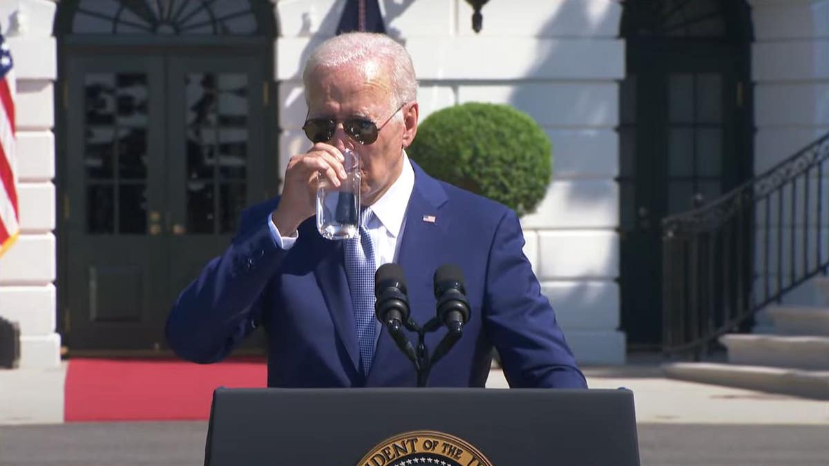 President Joe Biden drinking a glass of water