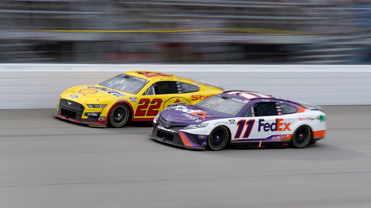 Denny Hamlin and Joey Logano jockey for position