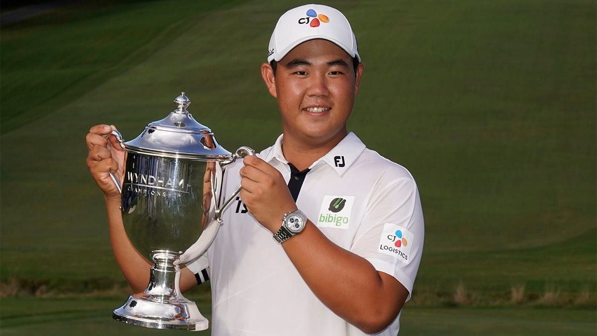 Joohyung Kim holds trophy