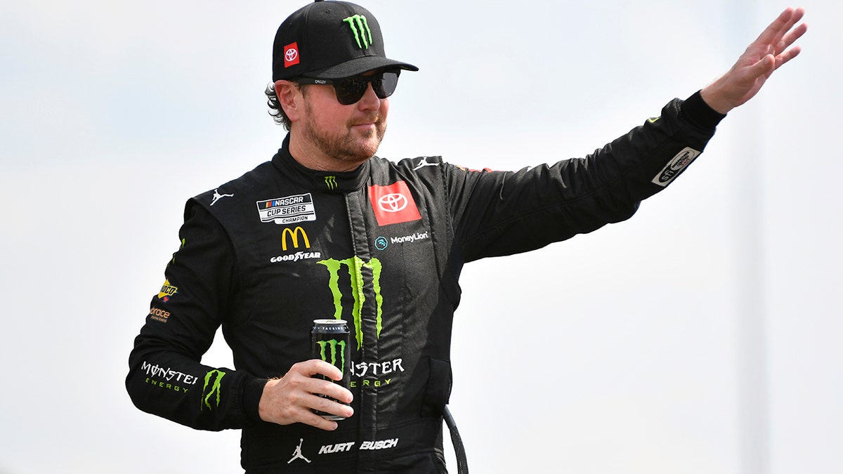 Kurt Busch, driver of the #45 Monster Energy Toyota, waves to fans onstage during driver intros prior to the NASCAR Cup Series Ally 400 at Nashville Superspeedway on June 26, 2022 in Lebanon, Tennessee.