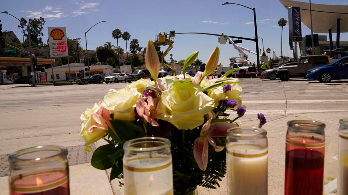 Flowers and candles are left on an intersection after after crash 
