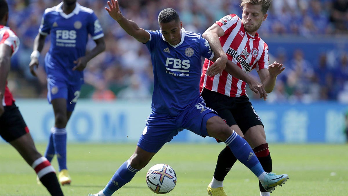Youri Tielemans and Mathias Jensen battle for ball