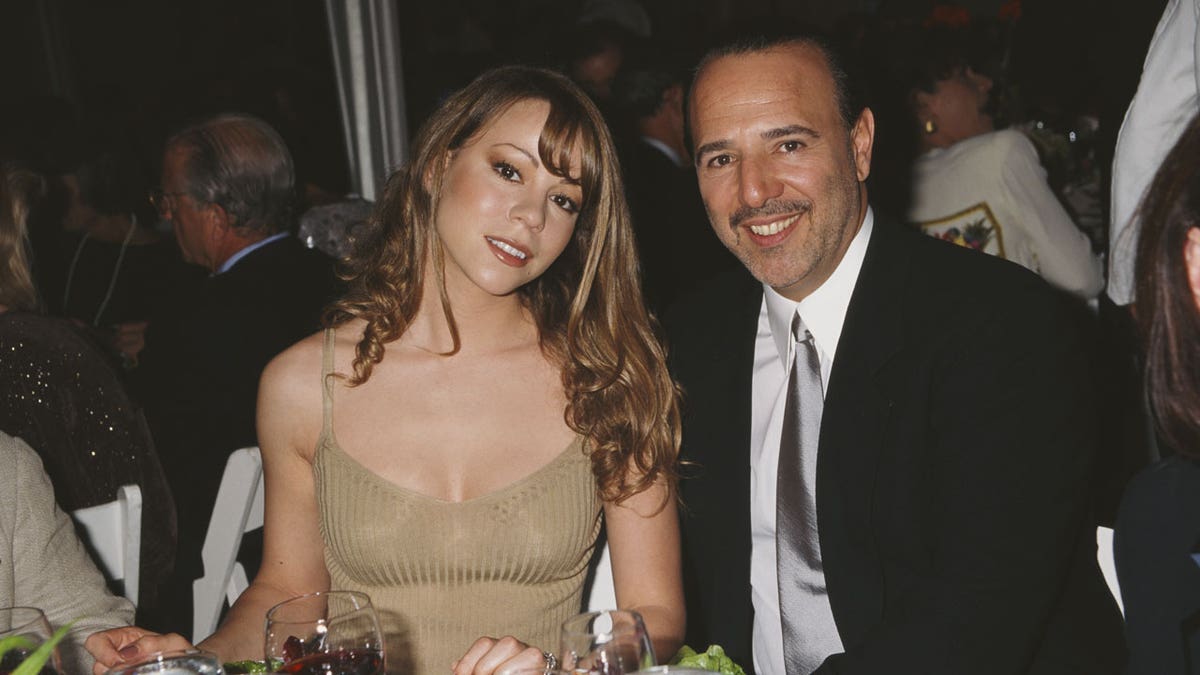Mariah Carey poses for a photo with Tommy Mottola