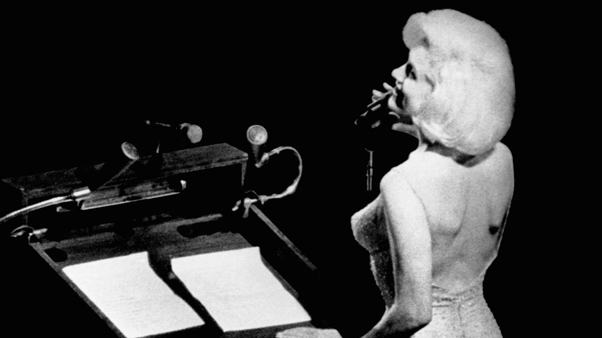 A close-up of Marilyn Monroe singing.
