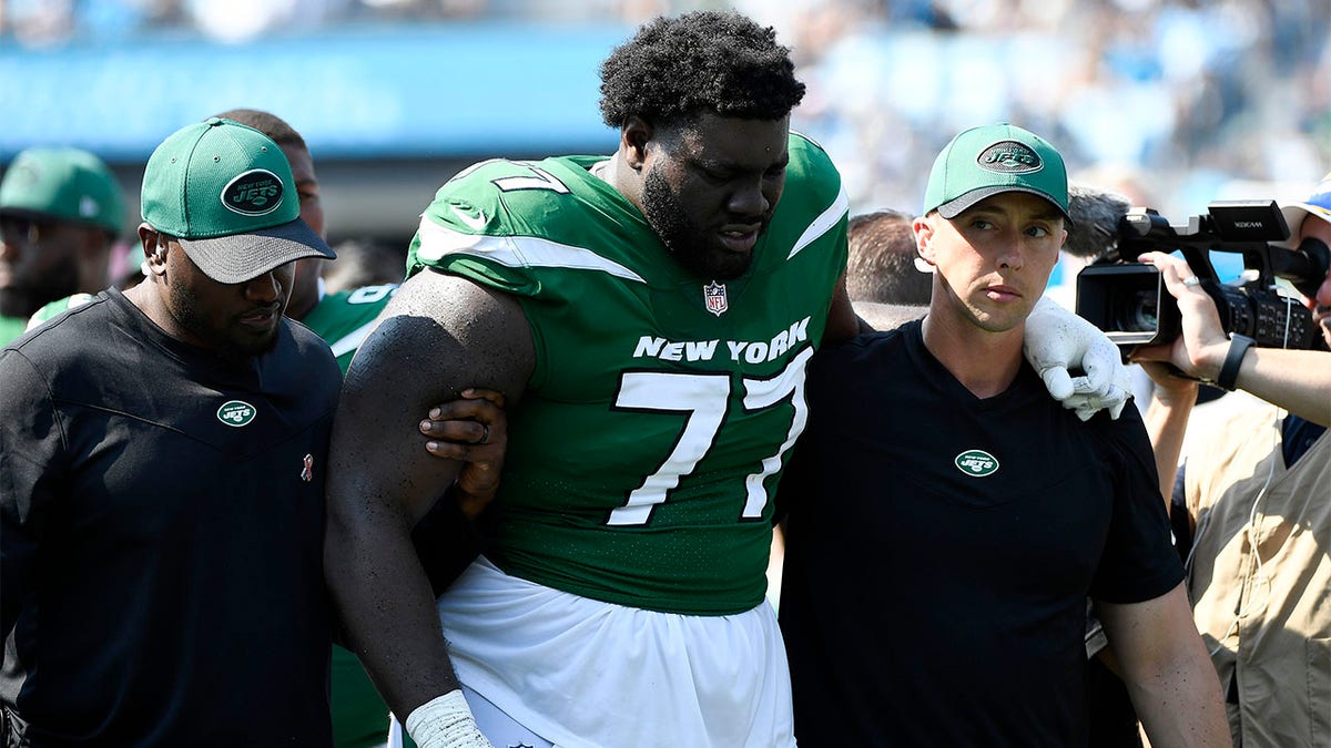 Mekhi Becton helped off field